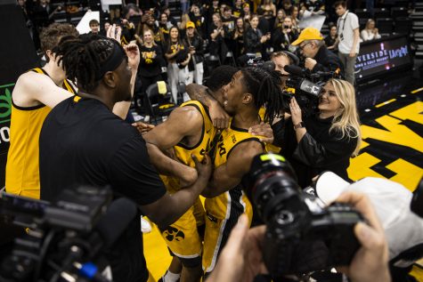 Iowa guards Ahron Ulis and Tony Perkins hug during a men’s basketball game between Iowa and Illinois at Carver-Hawkeye Arena in Iowa City on Saturday, Feb. 4, 2023. The Hawkeyes defeated the Illini, 81-79.