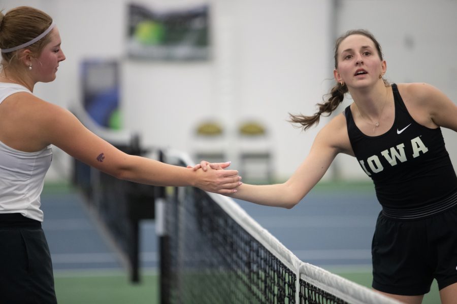 Kansas State’s Rozalia Gruszczynska and Iowa’s Marisa Schmidt shake hands after a match during a women’s tennis meet at the Hawkeye Tennis & Recreational Comple on Sunday, Feb. 5, 2023. The Hawkeyes defeated the Wildcats, 4,1.