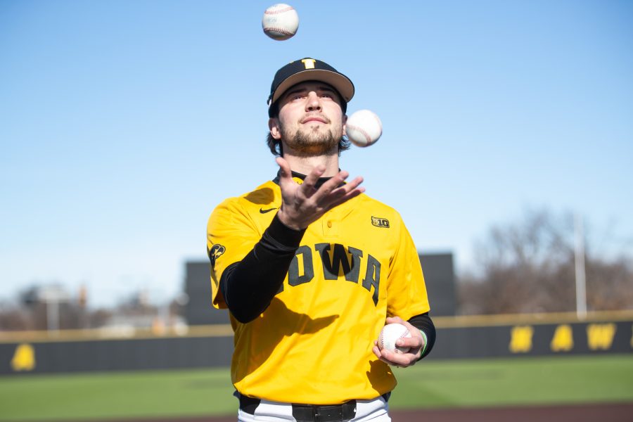 Iowa pitcher Zach Voelker juggles baseballs during the Iowa mens baseball media day at Duane Banks Baseball Stadium in Iowa City on February 8, 2023. With many new players on the field, head coach Rick Heller has his sights on Omaha.