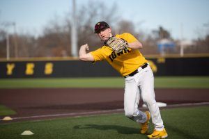 Iowa mens baseball infielder Sam Hojnar throws a baseball during the Iowa menÕs baseball media day at Duane Banks Baseball Stadium in Iowa City on February 8, 2023. With many new players on the field, head coach Rick Heller has his sights on Omaha.