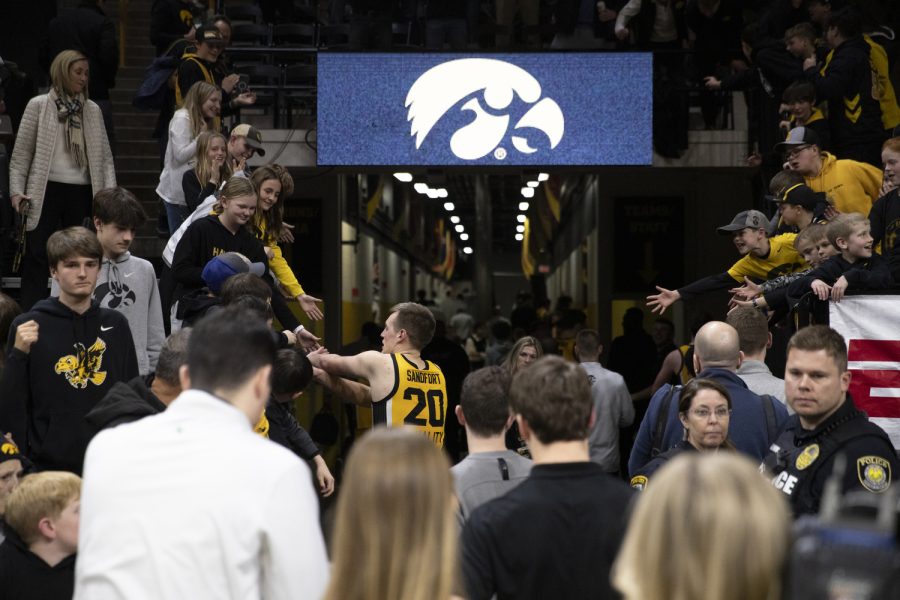Iowa forward Payton Sandfort high-fives fans after a men’s basketball game between Iowa and Ohio State at Carver-Hawkeye Arena in Iowa City on Thursday, Feb. 16, 2023. The Hawkeyes defeated the Buckeyes, 92-75.