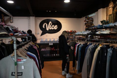 Customers look through the clothes on display at Vice in Iowa City on Feb. 22, 2023.