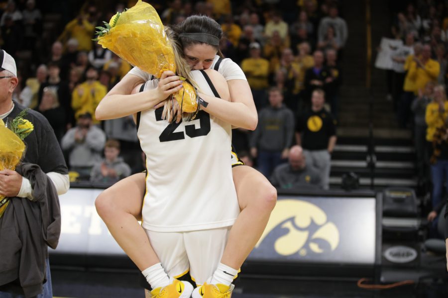 Iowa's McKenna Warnock  and Monika Czinano are acknowledged as a graduating seniors after a basketball game between No. 6 Iowa and No. 2 Indiana at Carver-Hawkeye Arena in Iowa City on Sunday, Feb. 26, 2023. The Hawkeyes defeated the Hoosiers 86-85 with a buzzer-beater by Caitlin Clark. Warnock and Czinano scored 8 and 13 points respectively in the game.