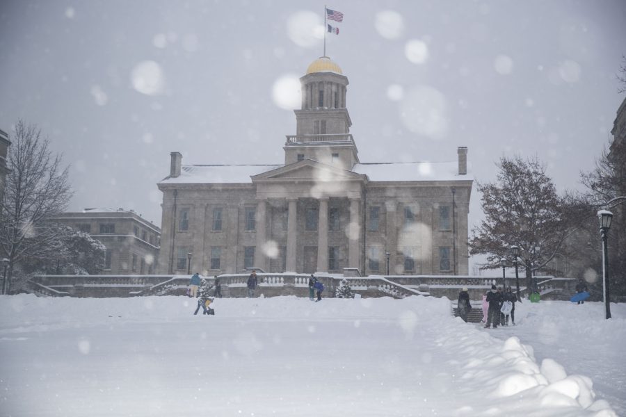 Students sled and snowboard on the Pentacrest on Thursday, Feb. 16, 2023. Several classes were canceled because of the weather. Snow totals in Iowa City were as high as 10.5 inches. (Ayrton Breckenridge/The Daily Iowan)