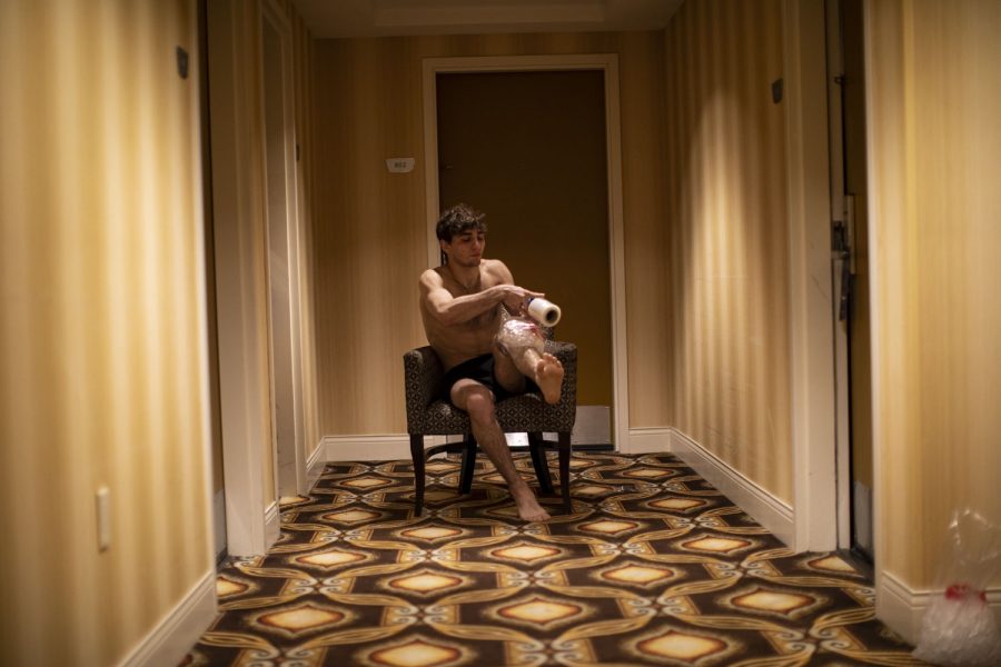 Iowa’s 133-pound Austin DeSanto applies ice to his knee in a hotel hallway at the DoubleTree Suites by Hilton Hotel Downtown Detroit on the second day of the 2022 NCAA Wrestling Tournament in Detroit, Mich. on Friday, March 18, 2022. DeSanto’s career record was 102-23. In the 2021-2022 season, DeSanto collected 45 team points in dual competition. 