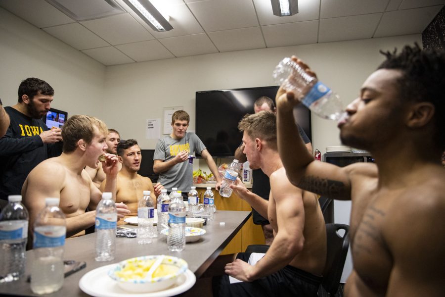 Iowa wrestlers eat after weigh-ins in the Dan Gable Wrestling Complex in Carver-Hawkeye Arena before a wrestling dual between No. 1 Iowa and No. 15 Purdue on Sunday, Jan. 9, 2022. Iowa’s 2021-22 regular season record was 14-1, and they finished in third place as a team at the 2022 NCAA wrestling tournament. 