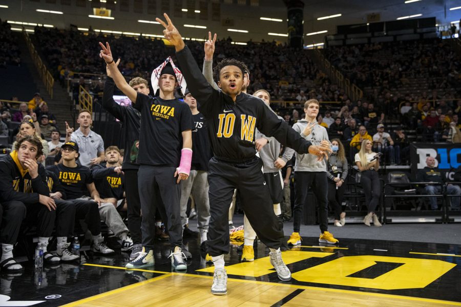 Iowa’s Charles Matthews signals for two points during a wrestling dual between No. 1 Iowa and No. 15 Purdue at Carver-Hawkeye Arena on Sunday, Jan. 9, 2022. Carver-Hawkeye Arena opened in 1983 and currently holds 15,500 fans. 