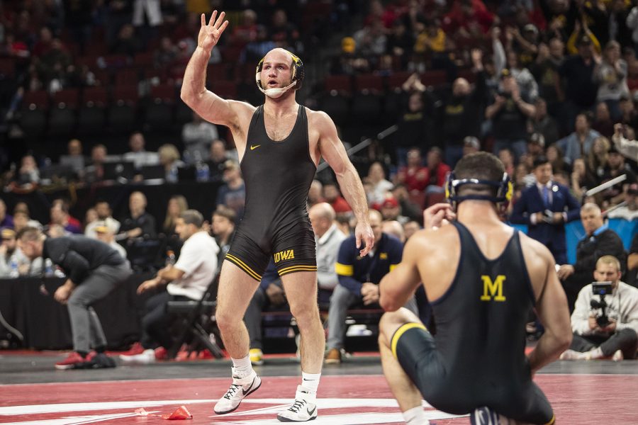 Iowas No. 2 Alex Marinelli raises his hand after earning first place during session five of the during session five of the Big Ten Wrestling Championships at Pinnacle Bank Arena in Lincoln, Neb., on Sunday, March 6, 2022. Marinelli defeated Michigans No. 4 Cameron Amine in a 165-pound match, 2-1. Marinelli earned his fourth Big Ten Championship win. Only 17 Big Ten wrestlers have ever accomplished this feat. 