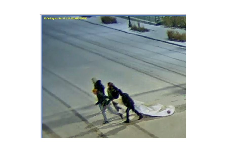 People run with a stolen inflatable rabbit from Downtown Iowa City Thursday at 1:50 a.m. 