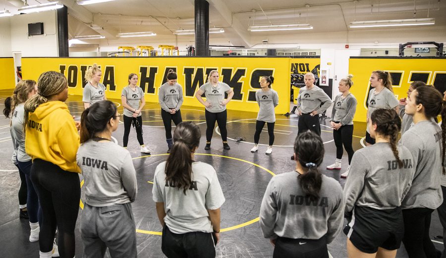 Iowa women’s wrestling head coach Clarissa Chun, associate head coach Gary Mayabb, and assistant coach Tonya Verbeek lead the team in a huddle during practice at Carver-Hawkeye Arena in Iowa City on Monday, Nov. 28, 2022. Mayabb was named associate head coach in May of 2022 and comes to Iowa following his membership status in the Missouri Wrestling Association, National Wrestling Coaches Association, Collegiate Wrestling Officials Association, National Wrestling Officials Association, and United States Wrestling Officials Association. 