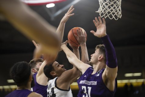 Iowa forward Kris Murray jumps to shoot the ball while Northwestern forward Robbie Beran attempts to block during a men’s basketball game between Iowa and Northwestern at Carver-Hawkeye Arena in Iowa City on Tuesday, Jan. 31, 2023. The Hawkeyes defeated the Wildcats, 86-70. 