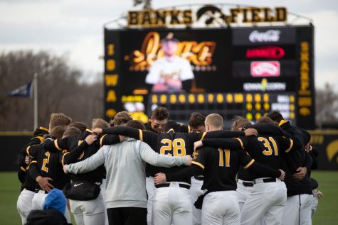 The Iowa baseball team huddles during a baseball game at Duane Banks Baseball Stadium in Iowa City on Tuesday, March 7, 2023. The Hawkeyes defeated the Kohawks, 8-2.
