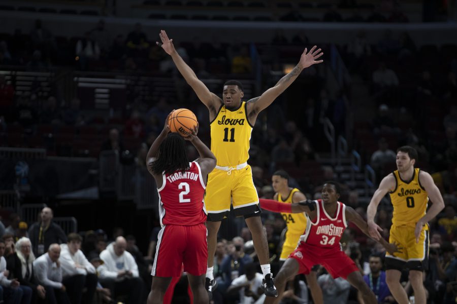Iowa guard Tony Perkins jumps to block a shot by Ohio State guard Bruce Thornton during a men’s basketball game between Iowa and Ohio State at United Center in Chicago on Thursday, March 9, 2023. The Buckeyes defeated the Hawkeyes, 73-69. Thornton scored 17 points and 6 assists.