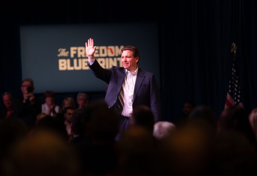 Florida Gov. Ron DeSantis waves during a Republican-hosted event in Davenport, Iowa, on Friday. DeSantis receives a standing ovation. (Cody Blissett/The Daily Iowan)
