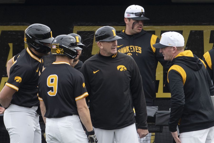Iowa head coach Rick Heller talks to his players during a baseball game between Iowa and St. Thomas at Duane Banks Field in Iowa City on Wednesday, March 15, 2023. The Hawkeyes defeated the Tommies, 10-1.