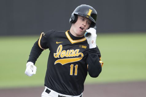 Iowa infielder Sam Peterson hits a grand slam during a baseball game between Iowa and St. Thomas at Duane Banks Field in Iowa City on Wednesday, March 15, 2023. The Hawkeyes defeated the Tommies, 10-1.