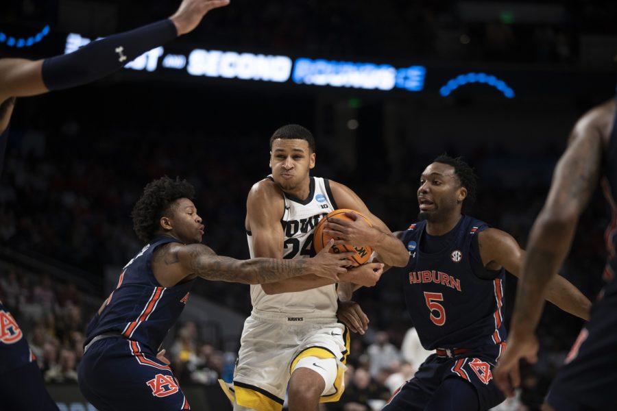 Iowa forward Kris Murray fights through Auburn players during a men’s basketball game between Iowa and Auburn in the first round of the NCAA Tournament at Legacy Arena in Birmingham, Ala., on Thursday, March 16, 2023. The Tigers defeated the Hawkeyes, 83-75.