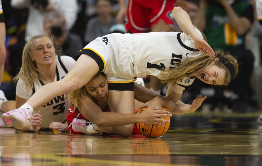 Iowa guard Molly Davis falls down during the 2023 NCAA Second Round women’s basketball game between No.2 Iowa and No.10 Georgia at a sold-out Carver Hawkeye Arena on Sunday, March 19, 2022. The Hawkeyes defeated the Lady Bulldogs, 74-66.