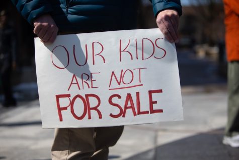Over 40 community members gather in the Iowa City pedestrian mall for the “Our Kids Are Not For Sale” protest against Iowa’s proposal to roll back child labor laws on Saturday, march 25, 2023. The protest was hosted by The Iowa City Federation of Labor. (Emily Nyberg/The Daily Iowan)
