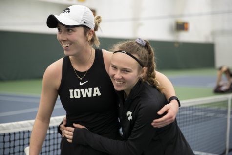 Iowa’s Samantha Mannix and Pia Kranholdt celebrate after a women’s tennis meet at the Hawkeye Tennis & Recreational Complex in Iowa City, on Saturday, March 25, 2023. Mannix and Kranholdt won both of their singles matches.