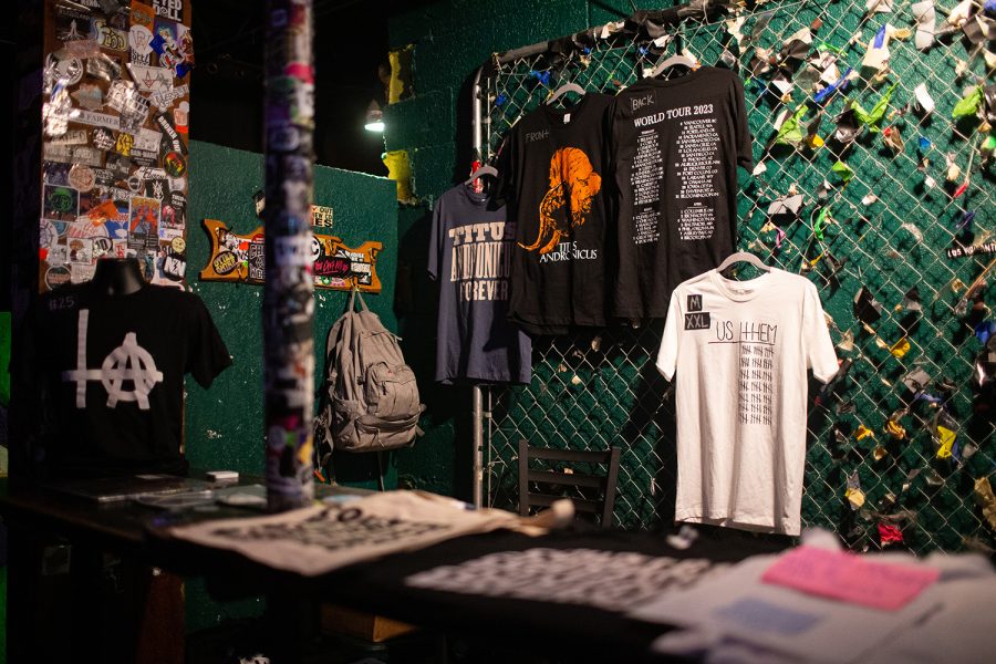 Band merchandise hangs at Gabe’s during a Titus Andronicus performance in Iowa City on Tuesday, March 29, 2023. (Cody Blissett/The Daily Iowan)