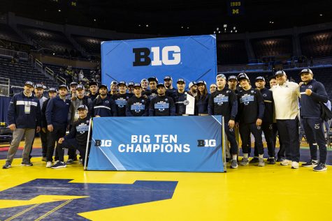 The Penn State wrestling team pose for photos after finish first team points during session four of the Big Ten Wrestling Championships at Crisler Center in Ann Arbor, Mich. on Sunday, March 5, 2023. The Nitnany Lions had 147.0 points and Hawkeyes finished second with 134.5.