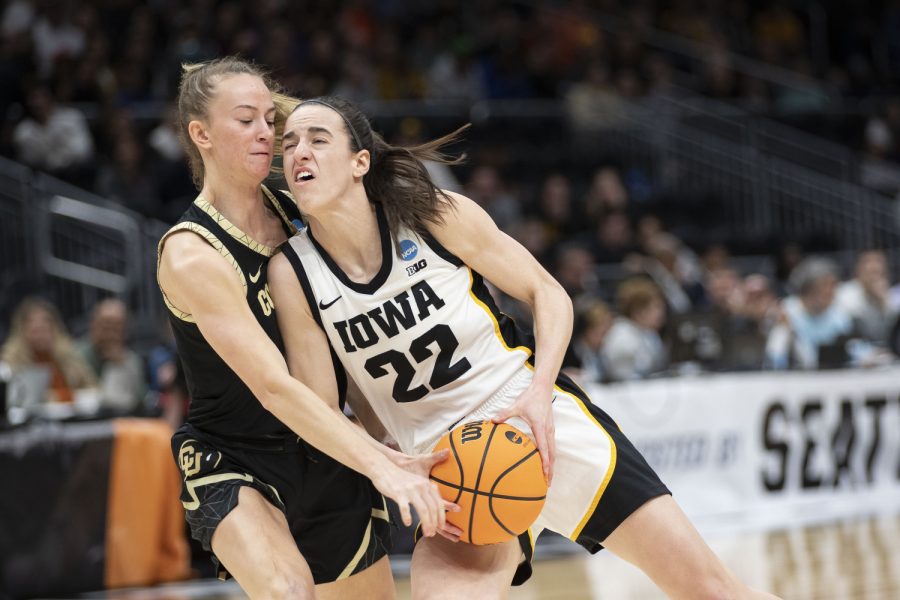 Iowa guard Caitlin Clark moves past Colorado guard Kendyll Wetta during the 2023 NCAA Sweet Sixteen women’s basketball game between No.2 Iowa and No.6 Colorado at Climate Pledge Arena in Seattle, WA on Friday, March 24, 2023. The Hawkeyes defeated the Buffaloes, 87-77.