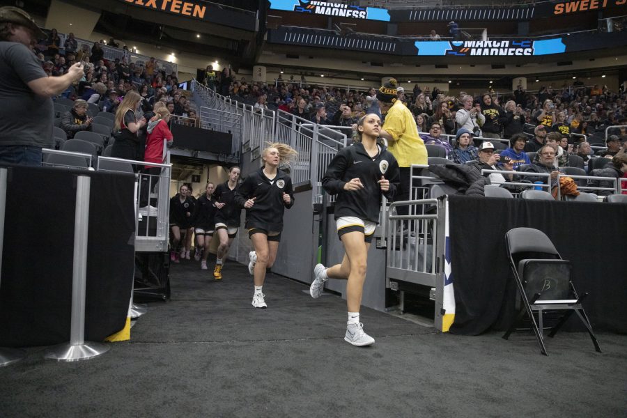 Iowa player run out of the tunnel during the 2023 NCAA Sweet Sixteen women’s basketball game between No.2 Iowa and No.6 Colorado at Climate Pledge Arena in Seattle, WA on Friday, March 24, 2023.The Buffalos leads The Hawkeyes, 40-39.