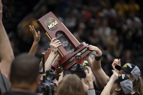 The Iowa team holds up the Seattle Regional 4 trophy after a victory over No.5 Louisville at the 2023 NCAA Elite Eight women’s basketball game at Climate Pledge Arena in Seattle, WA on Sunday, March 26, 2023. The Hawkeyes defeated the Cardinals, 97-83.