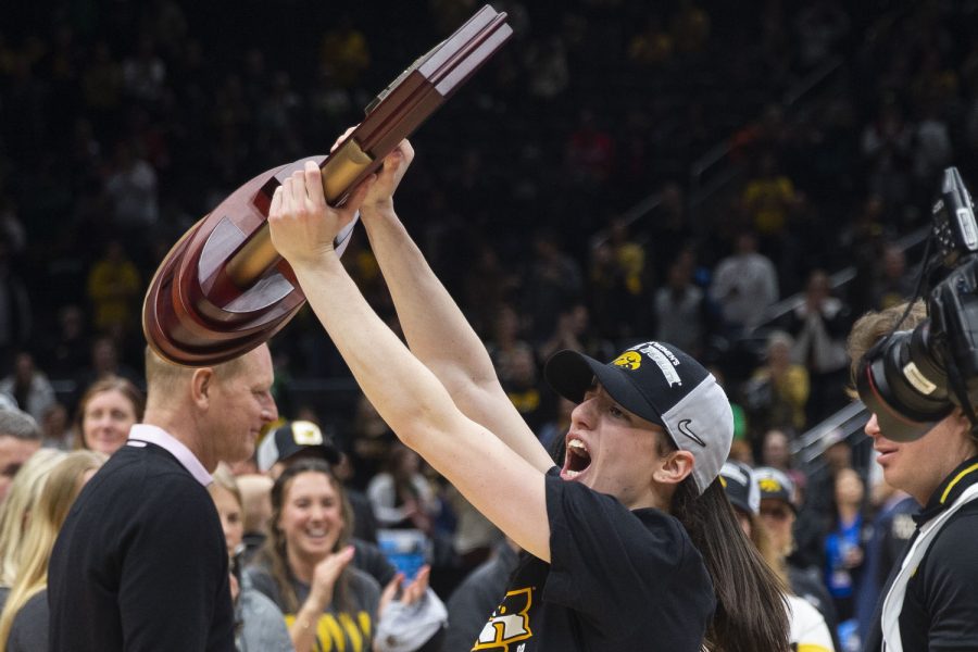 Iowa+guard+Caitlin+Clark+holds+up+the+Seattle+Regional+4+trophy+after+a+2023+NCAA+Elite+Eight+women%E2%80%99s+basketball+game+between+No.2+Iowa+and+No.5+Louisville+at+Climate+Pledge+Arena+in+Seattle%2C+WA+on+Sunday%2C+March+26%2C+2023.+The+Hawkeyes+defeated+the+Cardinals%2C+97-83.