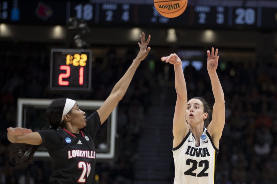 Iowa guard Caitlin Clark shoots a three-point shot during a 2023 NCAA Elite Eight women’s basketball game between No. 2 Iowa and No. 5 Louisville at Climate Pledge Arena in Seattle, WA on Sunday, March 25, 2023.