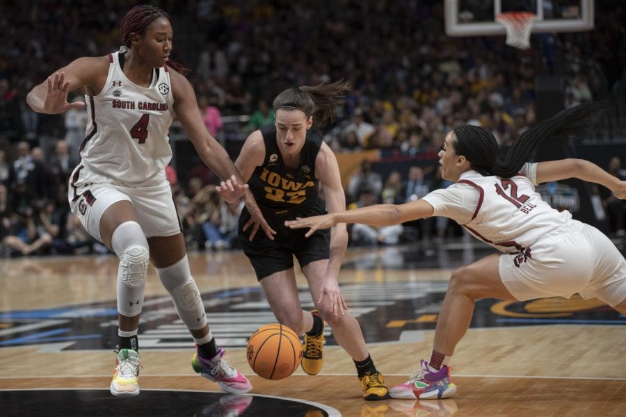 Iowa guard Caitlin Clark fights for a ball against South Carolina center Aliyah Boston in a NCAA Tournament Final Four matchup between No. 2 Iowa and No. 1 South Carolina at the American Airlines Center in Dallas, Texas, on Friday, March 31, 2023.