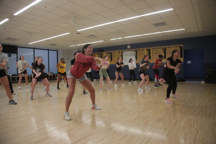 Iowa student Isabelle Bennett leads a WERQ fitness class at the Campus Recreations and Wellness Center on Tuesday, March 21, 2023.