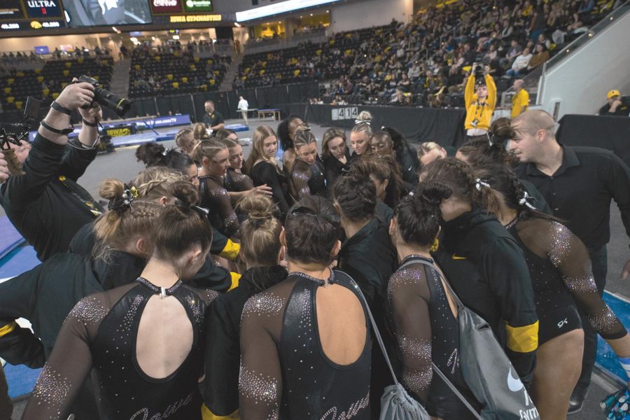 Iowa gymnastics team huddles during a gymnastics meet between No. 17 Iowa and No. 12 Michigan State at Xtream Arena on Saturday, Feb. 11, 2022. The Hawkeyes defeated the Spartans 196.150-195.725. 