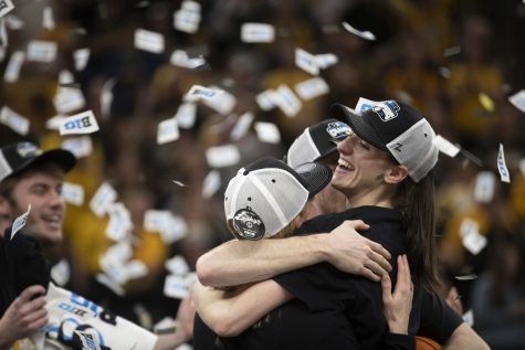Iowa womens basketball players celebrate after winning the Big Ten Tournament title at the Target Center in Minneapolis on March 5. Second-seeded Iowa defeated third-seeded Ohio State, 105-72.