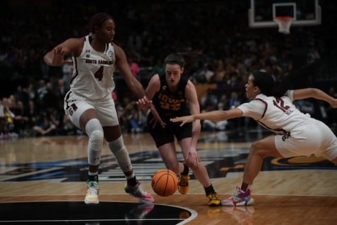 Iowa guard Caitlin Clark fights for a ball against South Carolina center Aliyah Boston in a NCAA Tournament Final Four matchup between No. 2 Iowa and No. 1 South Carolina at the American Airlines Center in Dallas, Texas, on Friday, March 31, 2023.