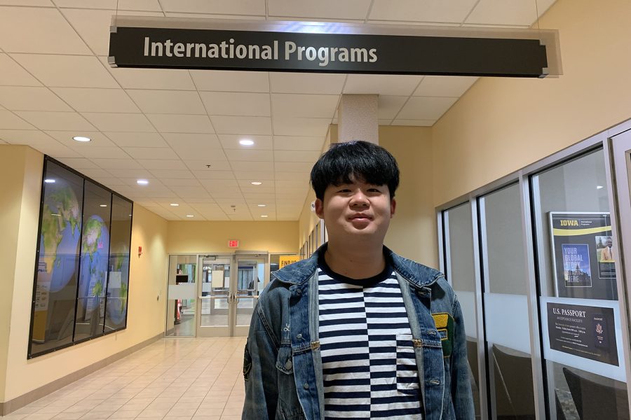 Hua Wei Lee poses for a portrait under the University of Iowa’s International Programs sign in the Old Capitol Mall on March 3, 2023. Lee, a third-year international student originally from Taiwan, said he almost always feels safe when out in Iowa City.