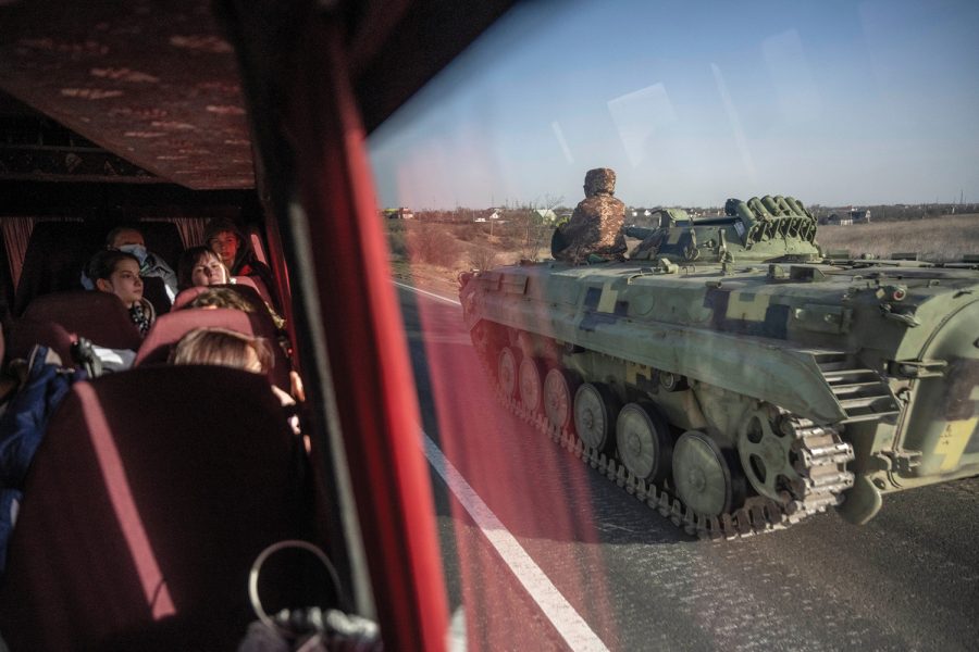 Ukrainian military forces are seen going in the opposite direction through the bus windows of Team Humanity as they evacuate soon-to-be war refugees to Moldova as they leave the war sieged city of Mykolaiv, Ukraine as on Sunday, March 27, 2022.