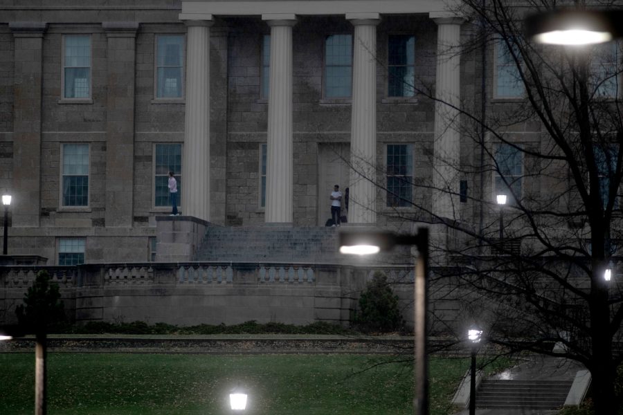 Students look at the sky during stormy weather on the Old Capitol steps in Iowa City on Sunday, March 31, 2023.