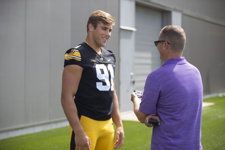 Iowa defensive linemen Lukas Van Ness interacts with a member of the media during Hawkeye Football Media Day at the Iowa Football practice faciltiy in Iowa City on Aug. 12, 2022