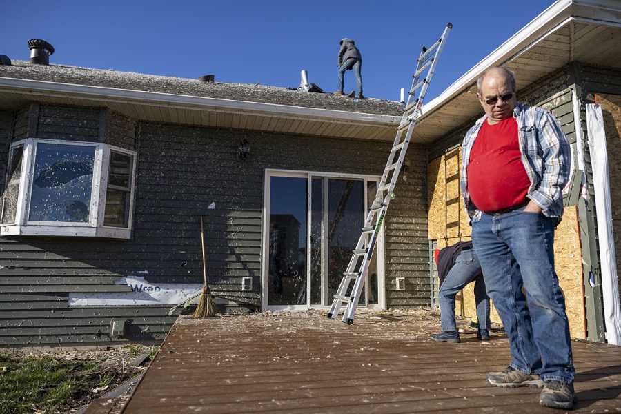 Bob Olson looks at the ground while helping sister-in-law Nancy Roselund cleanup her property in Hills, Iowa on Saturday, April 1, 2023 after a tornado went through parts of the town on Friday. The tornado impacted a new development in the city of 902 people. 