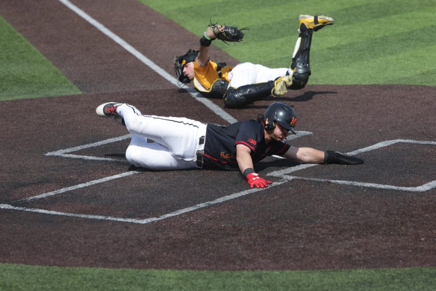 Maryland catcher Luke Shliger slides into home base during a baseball game between Iowa and Maryland at Duane Banks Baseball Stadium on Sunday, April 2, 2023. Hawkeyes defeated the Terrapins,  12-8.