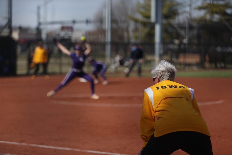 Volunteer assistant Erin Doug-Johnson coaches during the second game of a softball doubleheader between Iowa and No. 20 Northwestern at Bob Pearl Softball Fields on Sunday, April 2, 2023. The Hawkeyes defeated the Wildcats, 6-5. 