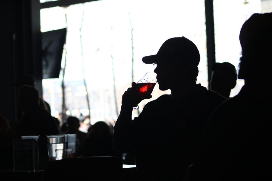 An Iowa fan sips wine during the women’s basketball team during a tense second half in the 2023 NCAA Women’s Basketball Championship Game watch party at Big Grove Brewery in Iowa City on Sunday, April 2, 2023. The Tigers defeated The Hawkeyes, 102-85.