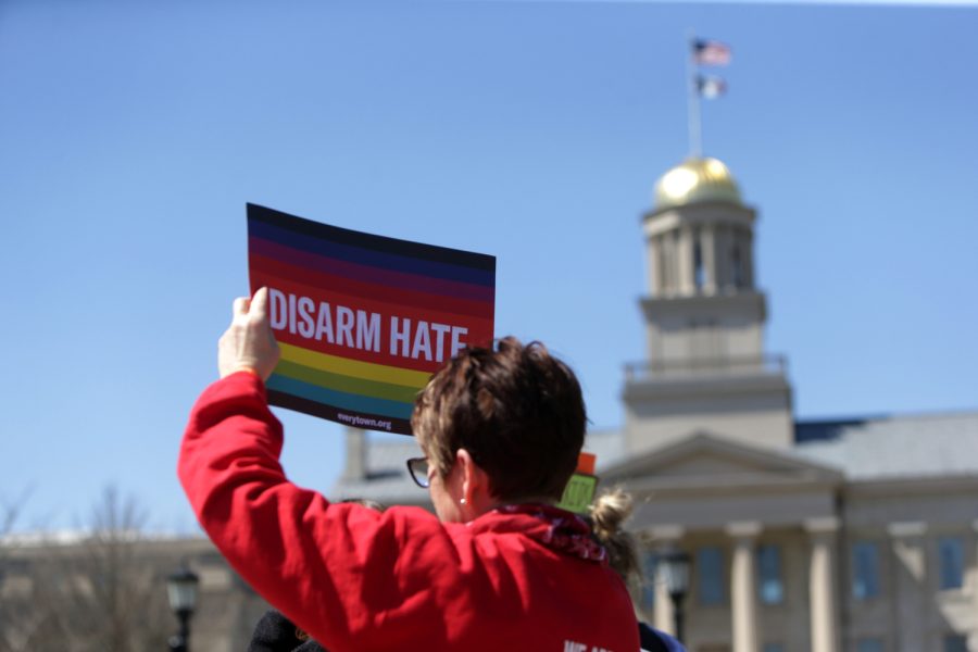 A person holds a sign that says Disarm hate on the Pentacrest in Iowa City, Iowa during the march for gun safety on Saturday, April 8, 2023. 