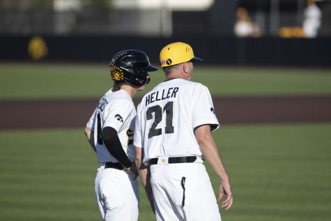 Iowa head coach Rick Heller talks to shortstop Michael Seegers during a baseball game between Iowa and Wisconsin-Milwaukee at Duane Banks Field on Wednesday, April 12, 2023. The Hawkeyes defeated the Panthers, 12-1.