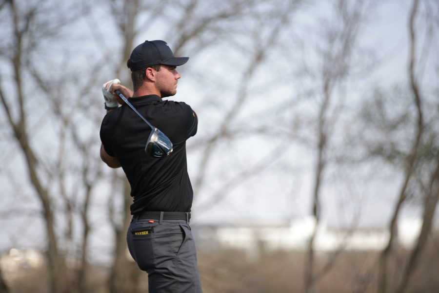 Iowa’s Hogan Hansen takes a shot during the Hawkeye invitational at Finkbine Golf Course in Iowa City on Friday, April 14, 2023. The Hawkeyes are leading after round one of three at the two-day tournament with Iowa’s Mac McClear leading the team in fifth place.