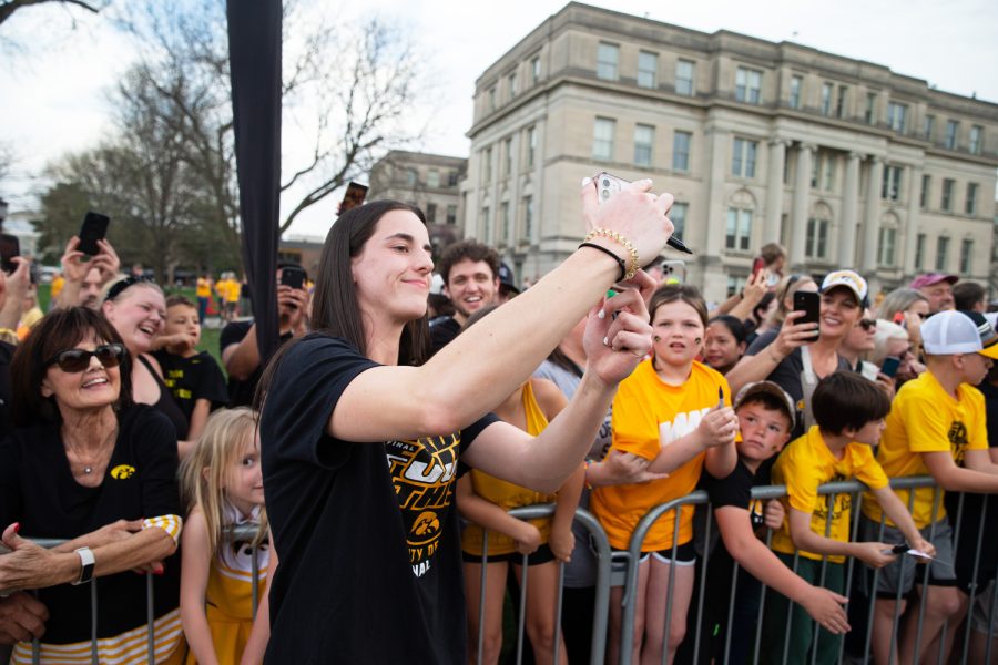Iowa guard Caitlin Clark takes a selfie during the Iowa Women’s basketball celebration on the Pentacrest in Iowa City on Friday, April 14, 2023.