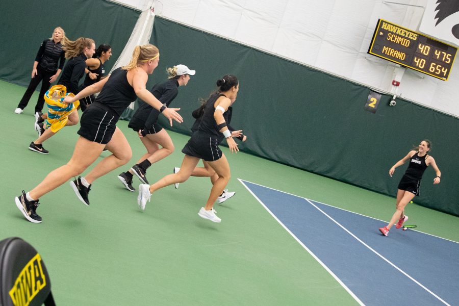 Iowa’s tennis team celebrates after a tennis meet at the Hawkeye Tennis & Recreational Complex in Iowa City on Sunday, April 16, 2023. The Hawkeye’s won, 4-3. 
