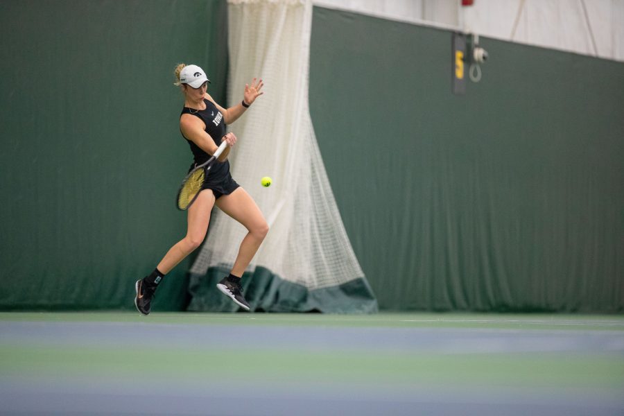 Iowa’s Samantha Mannix prepares to hit the ball during a tennis meet at the Hawkeye Tennis and Recreational Complex in Iowa City on Sunday, April 16, 2023. Mannix won her singles competition. The Hawkeyes won, 4-3. 